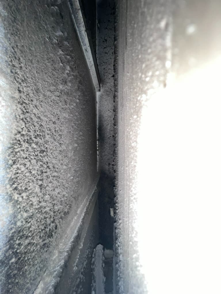 Close-up of deteriorated HVAC plenum tape and microbial growth inside air handler cabinet
