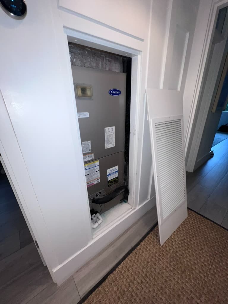 Carrier air handler unit in closet with return grille removed for HVAC mold inspection in Coral Gables, FL