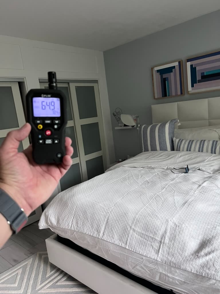 Thermo-hygrometer reading 64.9 degrees and 78.4 percent relative humidity near bedroom closet