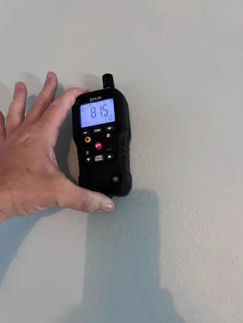 Non-invasive moisture meter testing on interior drywall in Sunrise, FL