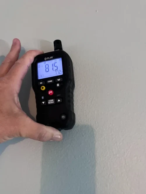 Non-invasive moisture meter testing on interior drywall in Sunrise, FL
