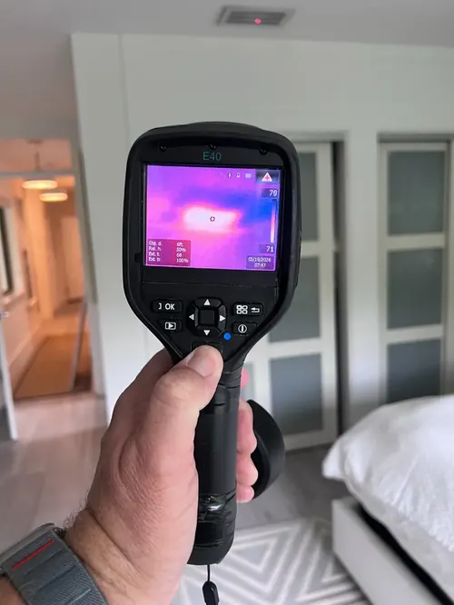 Thermal imaging camera detecting a moisture anomaly on a bedroom wall in Coral Springs, FL