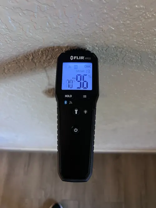 Moisture meter reading 96 percent relative humidity at a stained wall water track in Deerfield Beach, FL